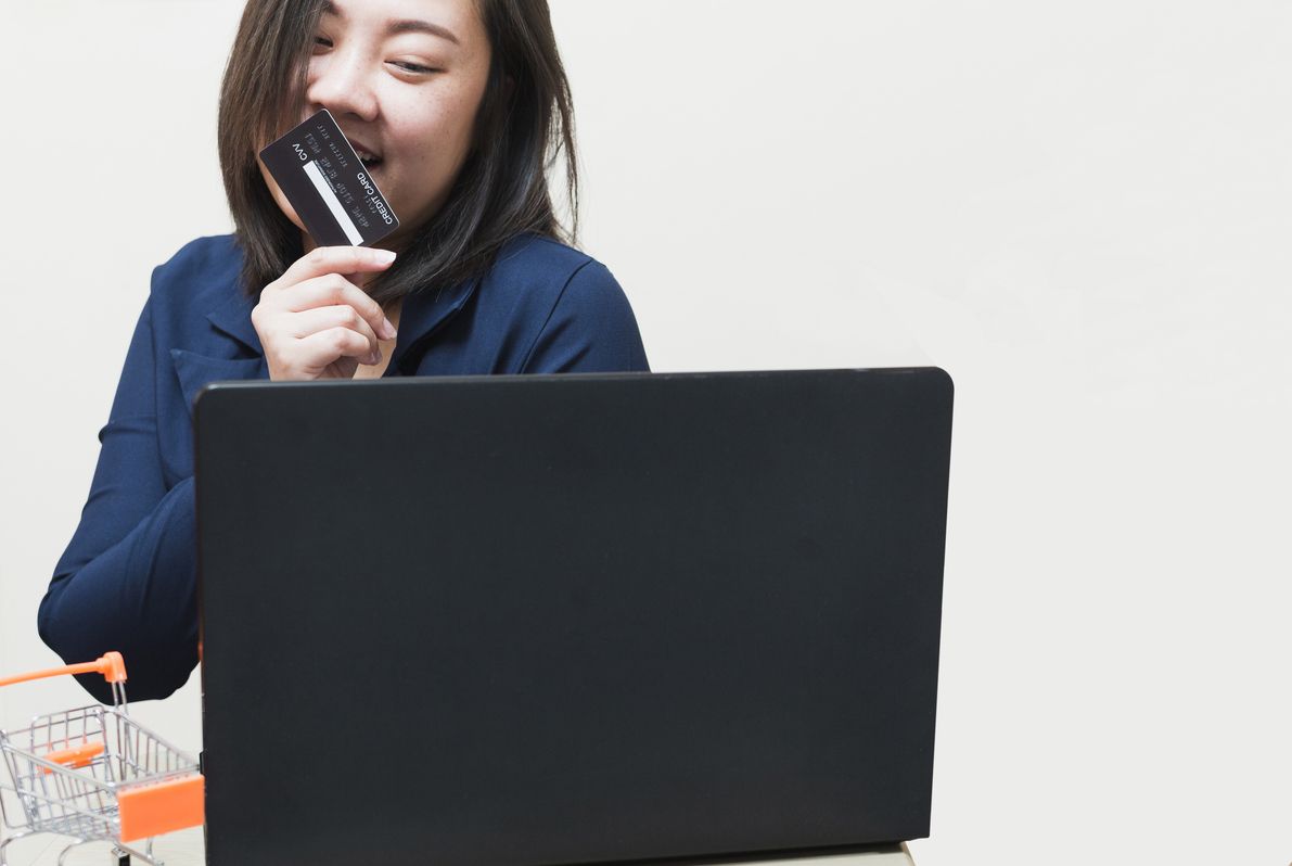 A woman holding a credit card