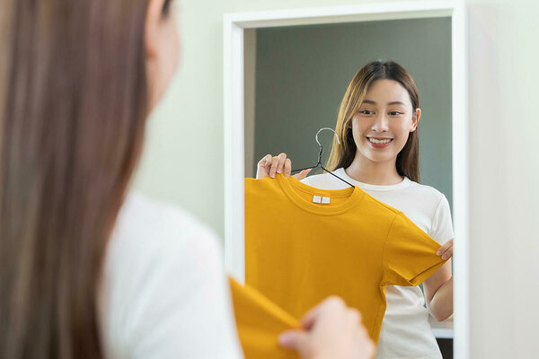 Woman choosing outfit at wardrobe